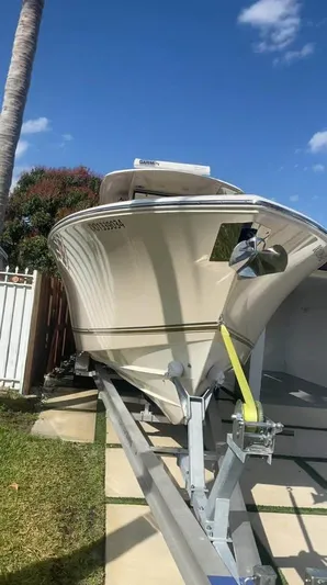  Yacht Photos Pics 2018 Cobia 344 Center Console boat on trailer under clear blue sky.