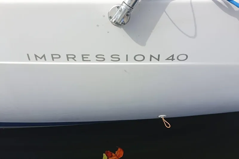  Yacht Photos Pics 2018 Elan Impression 40 yacht hull with visible branding and water reflection.