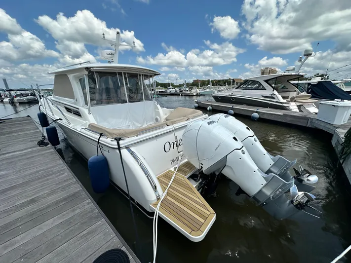  Yacht Photos Pics 2022 Back Cove 34O boat docked at marina under a partly cloudy sky.