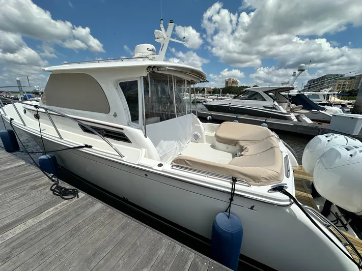  Yacht Photos Pics 2022 Back Cove 34O boat docked at marina under a partly cloudy sky.