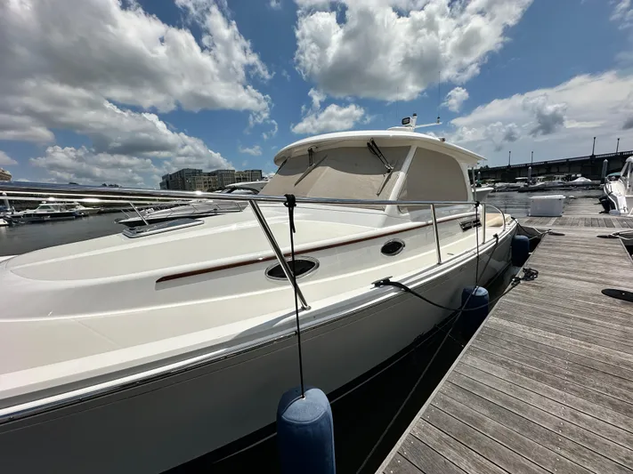  Yacht Photos Pics 2022 Back Cove 34O boat docked under a partly cloudy sky.