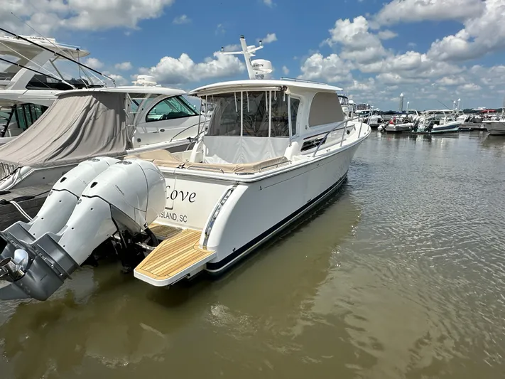  Yacht Photos Pics 2022 Back Cove 34O boat docked in marina under blue sky.