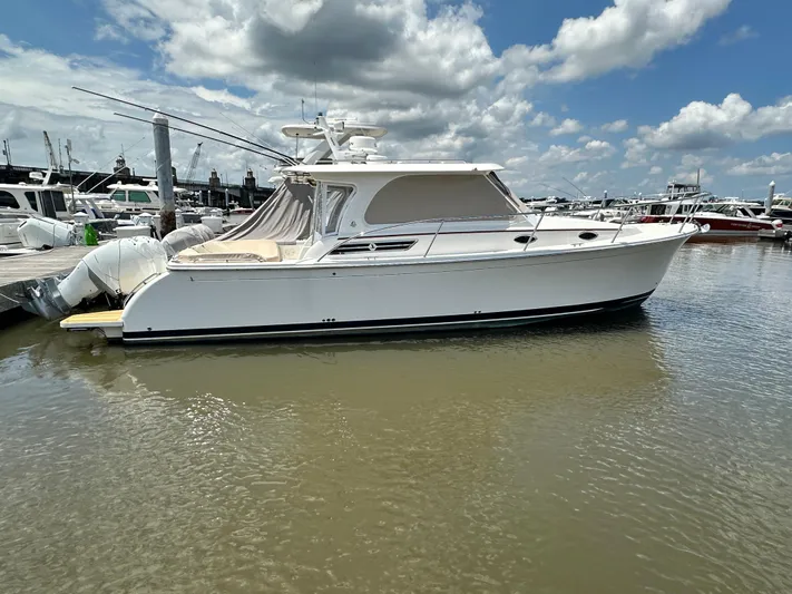  Yacht Photos Pics 2022 Back Cove 34O boat docked in marina under partly cloudy sky.