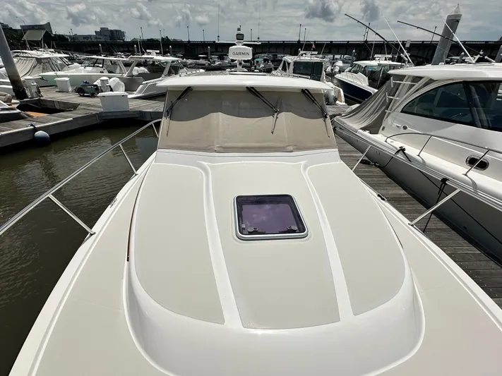  Yacht Photos Pics 2022 Back Cove 34O yacht docked at marina, showcasing sleek design and spacious deck.