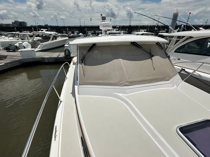  Yacht Photos Pics 2022 Back Cove 34O yacht docked at marina under cloudy sky.