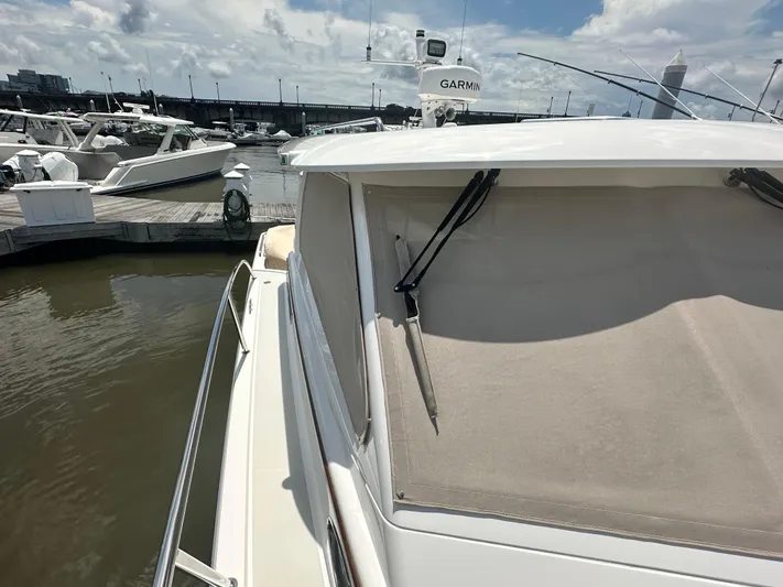  Yacht Photos Pics 2022 Back Cove 34O yacht docked at marina under cloudy sky.