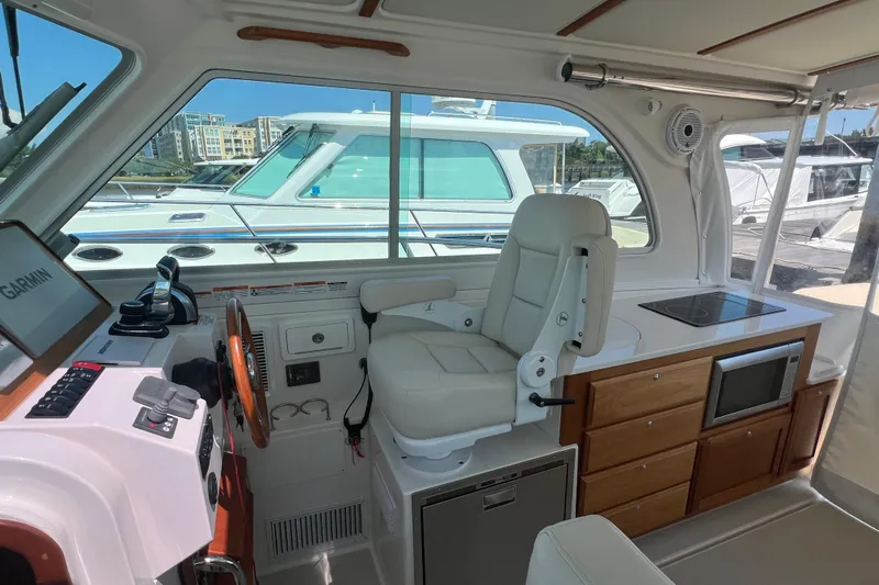  Yacht Photos Pics Interior of 2022 Back Cove 34O boat with helm, seating, and kitchenette.