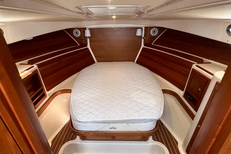 Yacht Photos Pics Luxurious cabin interior of 2022 Back Cove 34O yacht with cozy bed and wooden accents.