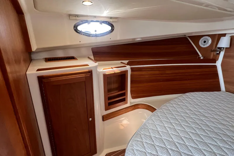  Yacht Photos Pics Interior of 2022 Back Cove 34O boat with wood paneling and porthole window.