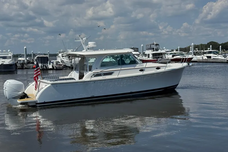  Yacht Photos Pics 2022 Back Cove 34O boat docked in a marina under a cloudy sky.
