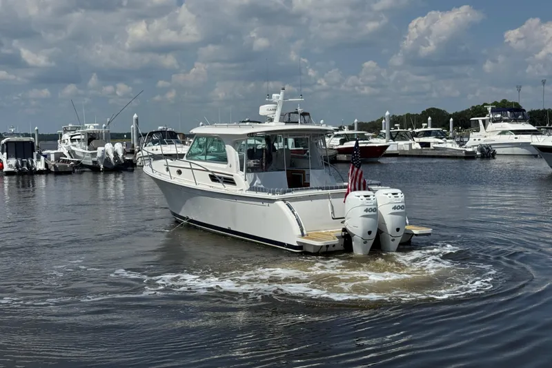  Yacht Photos Pics 2022 Back Cove 34O boat with twin engines in a marina setting.