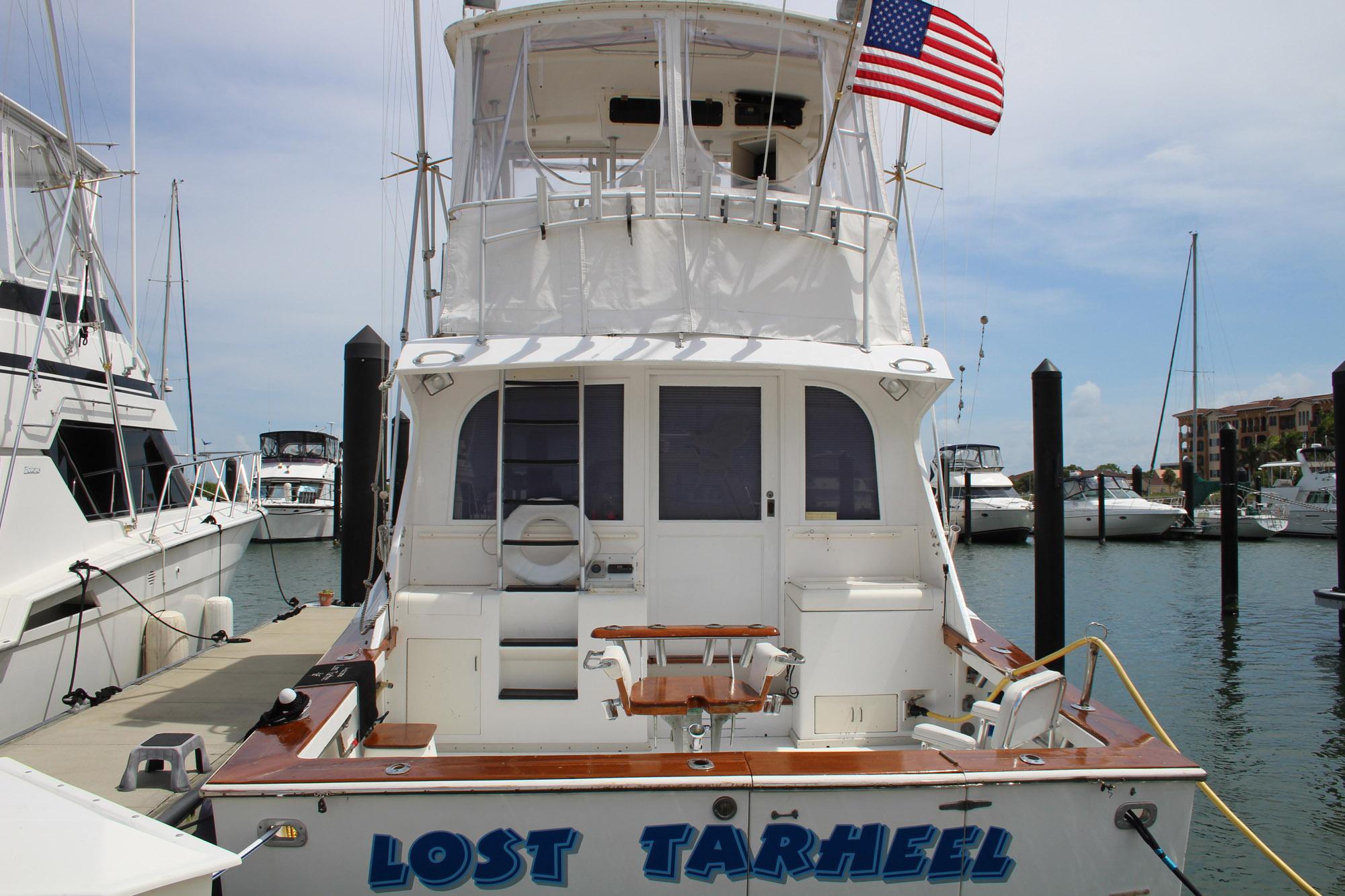 1990 Post 44 Sport Fisherman boat named "Lost Tarheel" docked at a marina.