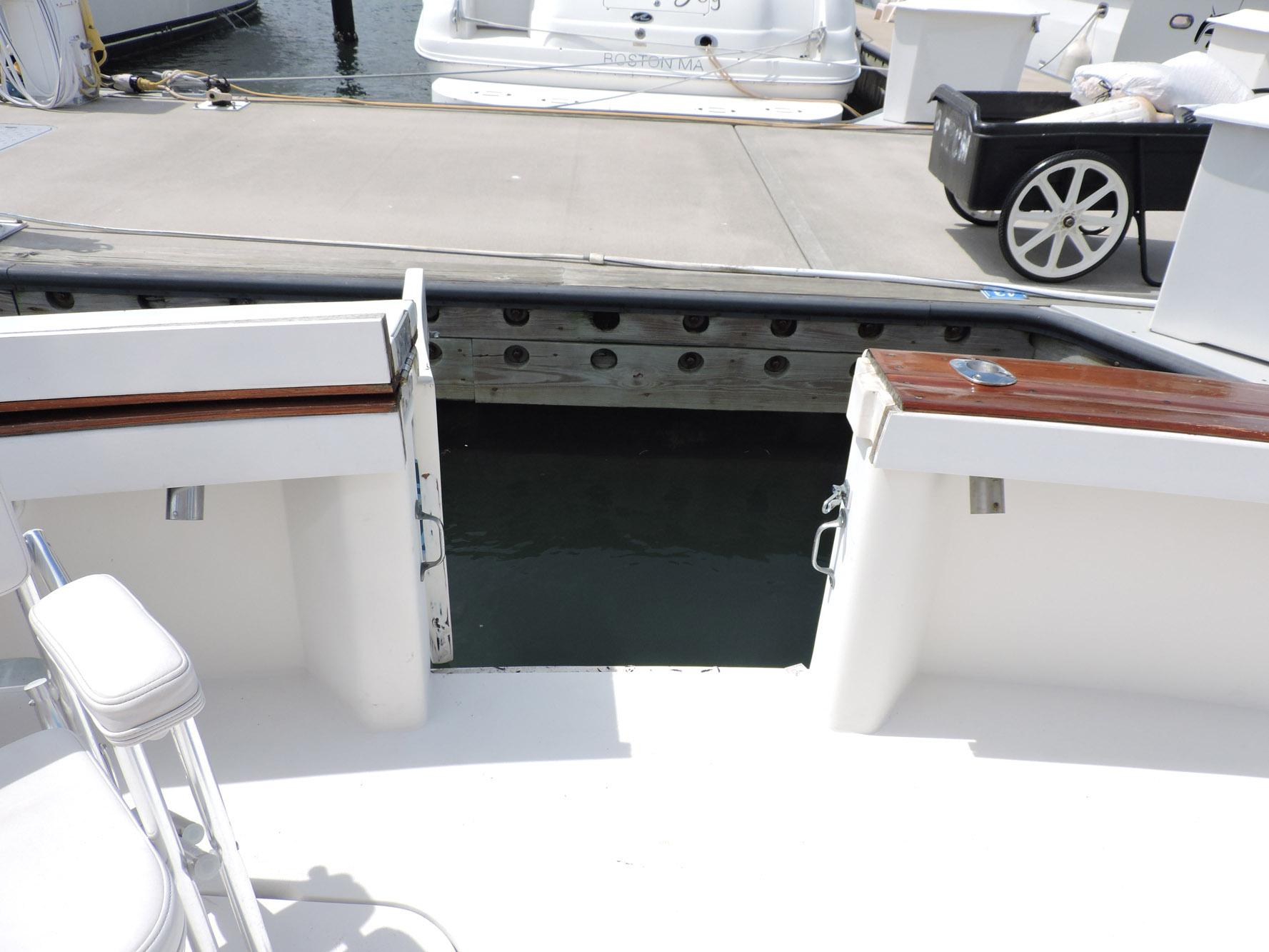 1990 Post 44 Sport Fisherman boat docked, featuring open deck and seating area.