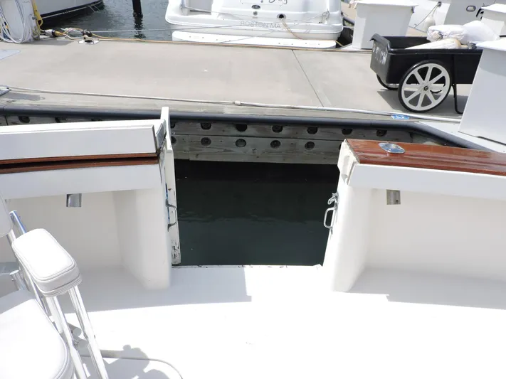  Yacht Photos Pics 1990 Post 44 Sport Fisherman boat docked, featuring open deck and seating area.