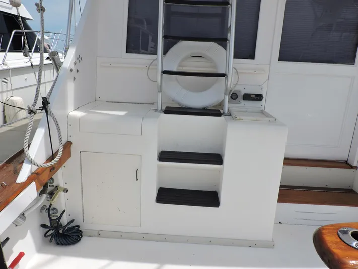  Yacht Photos Pics 1990 Post 44 Sport Fisherman boat deck with ladder and storage compartments.