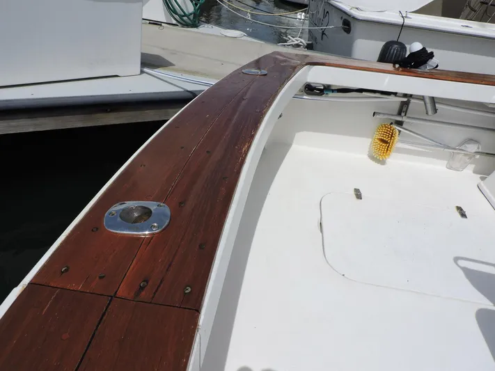  Yacht Photos Pics 1990 Post 44 Sport Fisherman boat deck with wooden railing and fishing equipment.