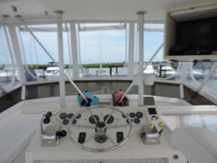  Yacht Photos Pics Helm of 1990 Post 44 Sport Fisherman boat with steering wheel and controls.
