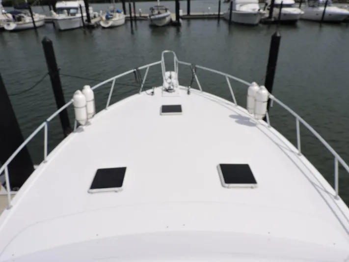  Yacht Photos Pics 1990 Post 44 Sport Fisherman boat docked at marina, view from bow.