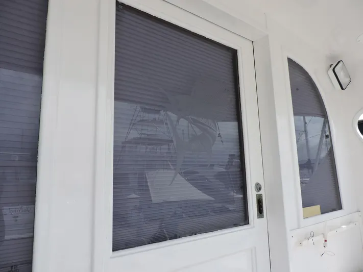  Yacht Photos Pics 1990 Post 44 Sport Fisherman boat with closed cabin door and window blinds.