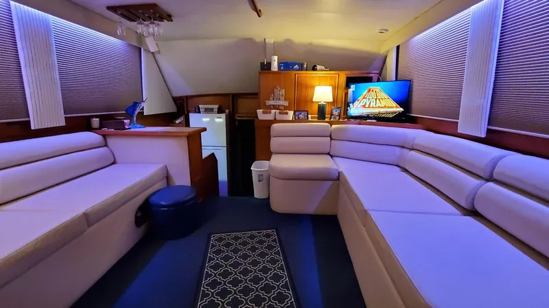  Yacht Photos Pics Luxurious interior of a 1990 Post 44 Sport Fisherman yacht with cozy seating and ambient lighting.