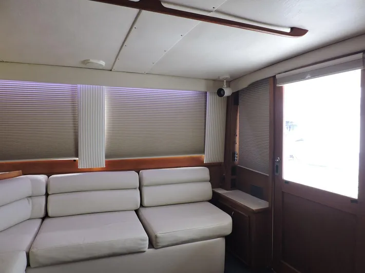  Yacht Photos Pics Interior of 1990 Post 44 Sport Fisherman with white seating and wooden accents.