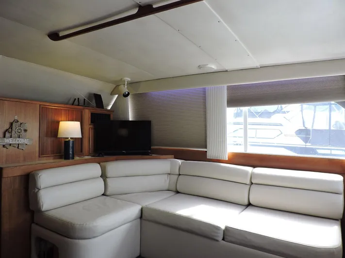  Yacht Photos Pics Interior of 1990 Post 44 Sport Fisherman yacht with white leather seating and wooden accents.
