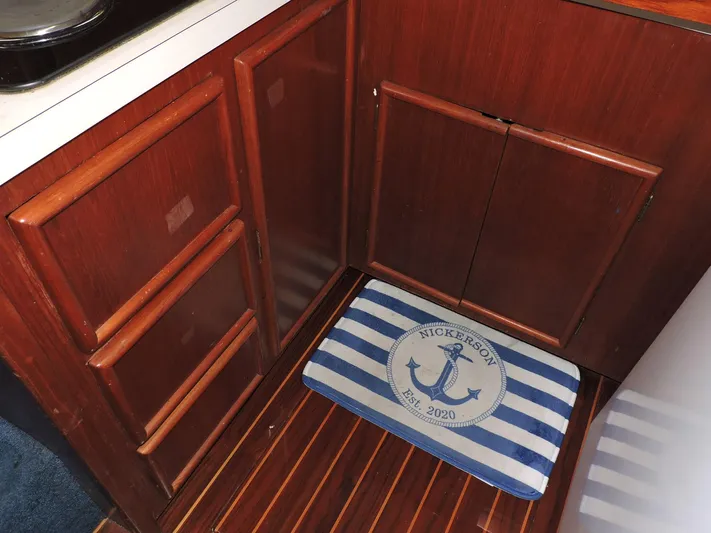 Yacht Photos Pics Wooden cabinet and striped mat in 1990 Post 44 Sport Fisherman boat interior.