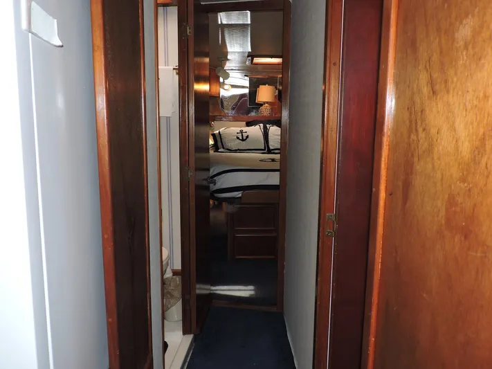  Yacht Photos Pics Narrow hallway inside 1990 Post 44 Sport Fisherman boat, leading to a cozy cabin.