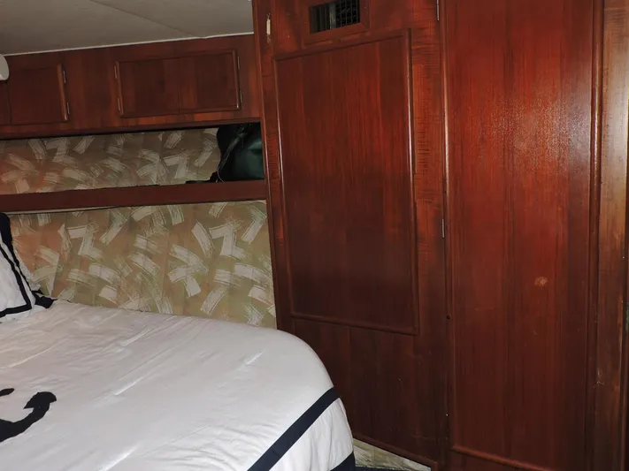  Yacht Photos Pics Interior cabin of 1990 Post 44 Sport Fisherman with wood paneling and bed.