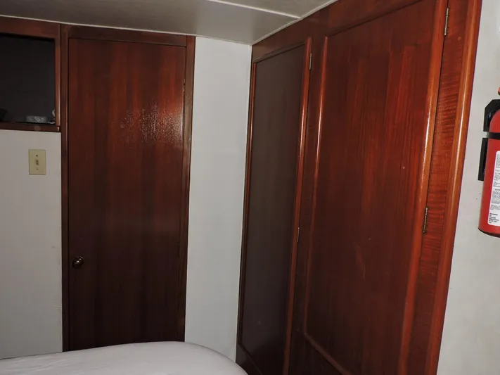  Yacht Photos Pics Interior of 1990 Post 44 Sport Fisherman with wooden doors and fire extinguisher.