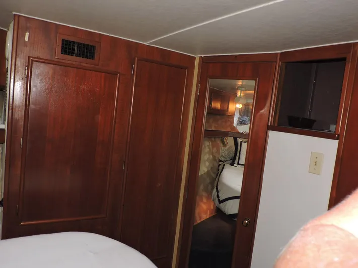  Yacht Photos Pics Interior of 1990 Post 44 Sport Fisherman yacht with wooden cabinetry and cozy sleeping area.