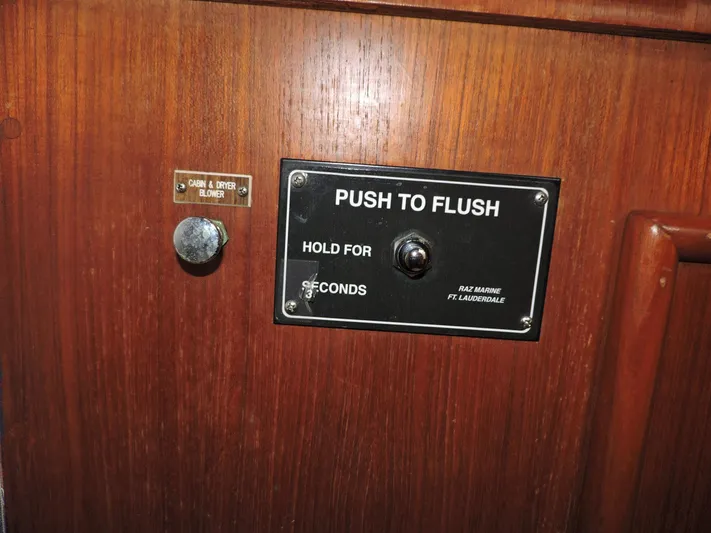  Yacht Photos Pics 1990 Post 44 Sport Fisherman boat flush control panel on wooden surface.