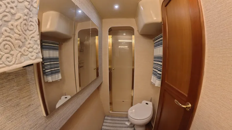 No Name Yacht Photos Pics Luxurious bathroom in 2002 Ocean Yachts 52 SUPER SPORT, featuring shower and elegant wood finishes.