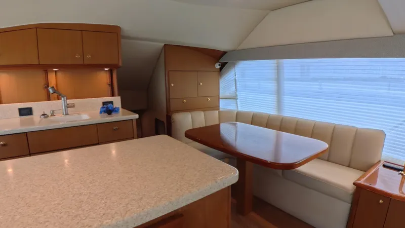 No Name Yacht Photos Pics Luxurious interior of 2002 Ocean Yachts 52 SUPER SPORT with dining area and kitchenette.