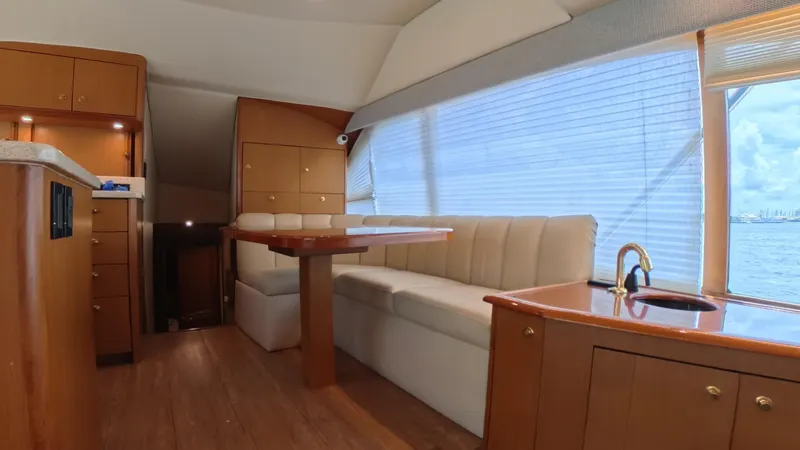 No Name Yacht Photos Pics Luxurious interior of 2002 Ocean Yachts 52 SUPER SPORT with elegant wood finishes and seating.