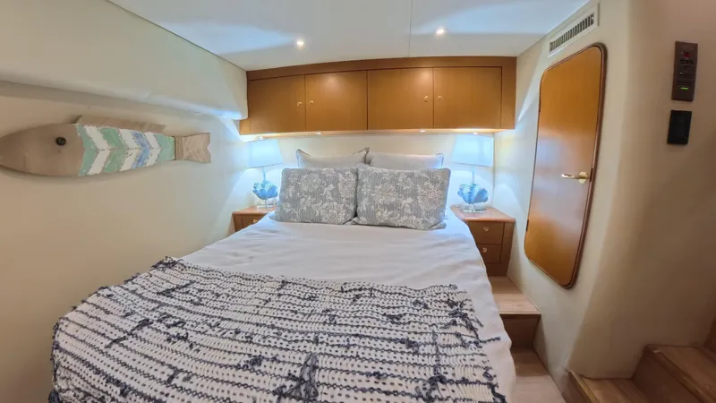 No Name Yacht Photos Pics Cozy bedroom in 2002 Ocean Yachts 52 SUPER SPORT with nautical decor and soft lighting.