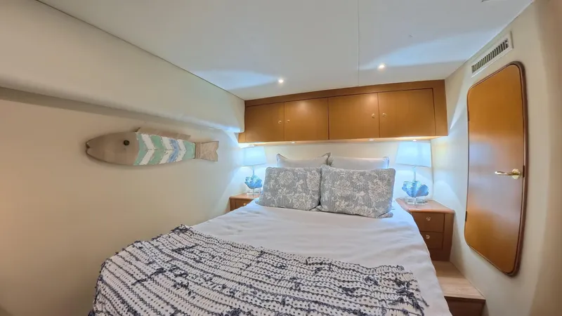 No Name Yacht Photos Pics Luxurious bedroom interior of 2002 Ocean Yachts 52 SUPER SPORT with cozy bedding and elegant decor.