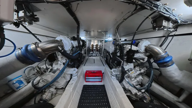 No Name Yacht Photos Pics Engine room of 2002 Ocean Yachts 52 SUPER SPORT, showcasing mechanical components and piping.