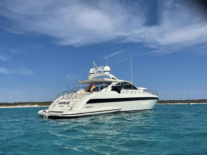  Yacht Photos Pics Luxury 2006 Mangusta 80 yacht on clear blue water under a bright sky.