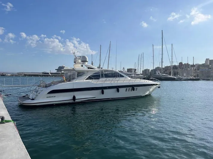  Yacht Photos Pics Luxury 2006 Mangusta 80 yacht docked in a marina under a clear blue sky.
