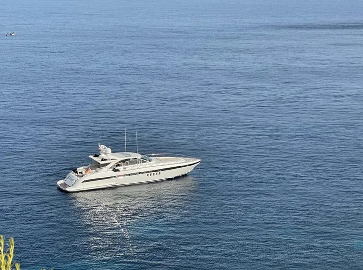  Yacht Photos Pics 2006 Mangusta 80 yacht cruising on calm blue waters.