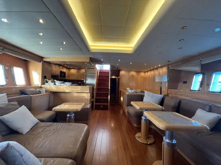  Yacht Photos Pics Luxurious interior of a 2006 Mangusta 80 yacht with elegant wood finishes and plush seating.