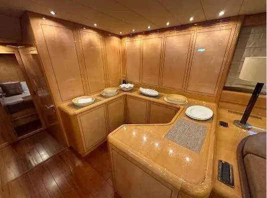  Yacht Photos Pics Luxurious interior of 2006 Mangusta 80 yacht with elegant wood paneling and ambient lighting.