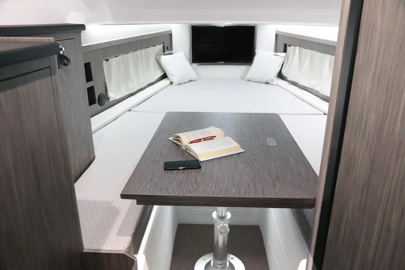  Yacht Photos Pics Luxurious interior of 2025 Ranieri CAYMAN 45.0 Cruiser with cozy seating and modern table.