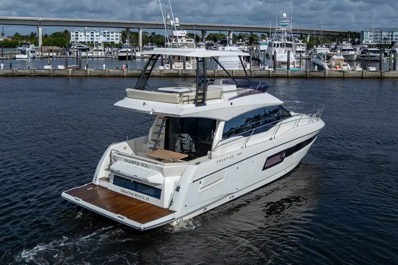 Pamper You Yacht Photos Pics 2019 Prestige 460 yacht cruising in a marina, showcasing sleek design and luxury features.