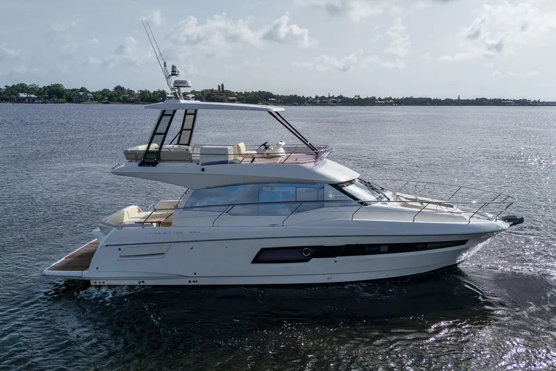 Pamper You Yacht Photos Pics 2019 Prestige 460 yacht cruising on calm waters under a cloudy sky.