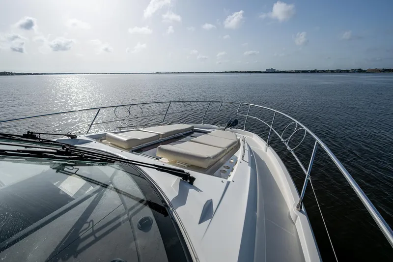 Pamper You Yacht Photos Pics 2019 Prestige 460 yacht with sun loungers on deck, cruising on calm waters.