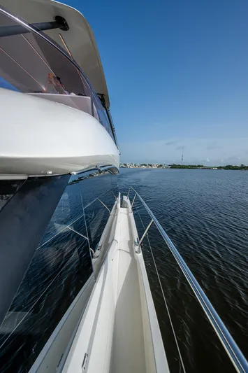 Pamper You Yacht Photos Pics Prestige 460 yacht, 2019 model, cruising on calm waters under a clear blue sky.