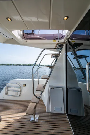 Pamper You Yacht Photos Pics 2019 Prestige 460 yacht with elegant interior stairs and scenic water view.