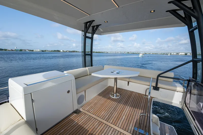 Pamper You Yacht Photos Pics Luxurious 2019 Prestige 460 yacht deck with seating, table, and scenic ocean view.